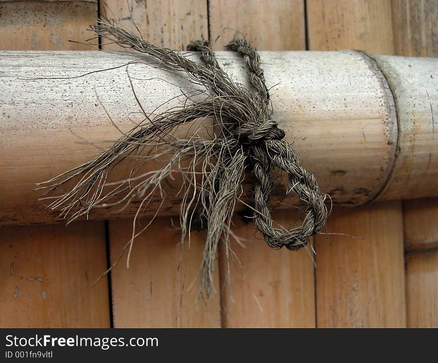 Bamboo wood fence detail-focus on the knot,the fence in background is blurred