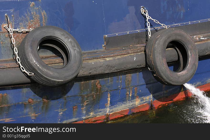 Tires tied to the side of a tugboat