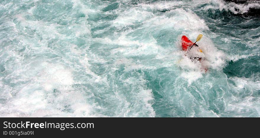 A kayaker in a class 5 rapid