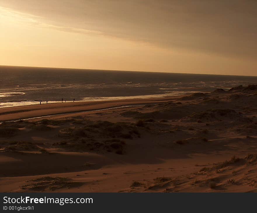 The sun goes down off the beach, and a mist softens the view. The sun goes down off the beach, and a mist softens the view.