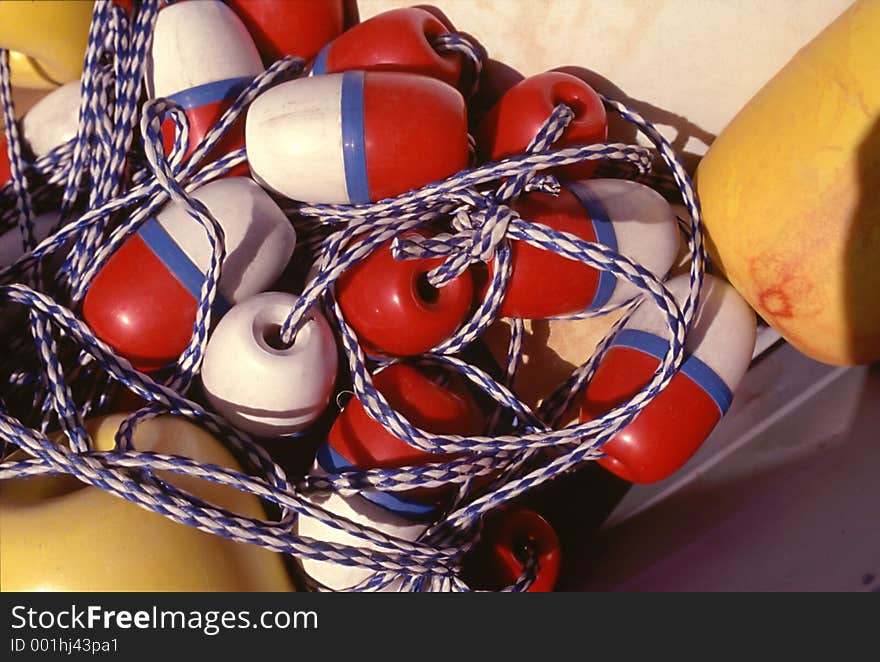 Yellow red white and blue buoys on the ropes. Yellow red white and blue buoys on the ropes