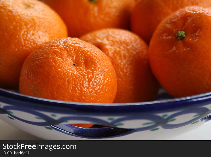 blue & white ceramic dish containing oranges. blue & white ceramic dish containing oranges