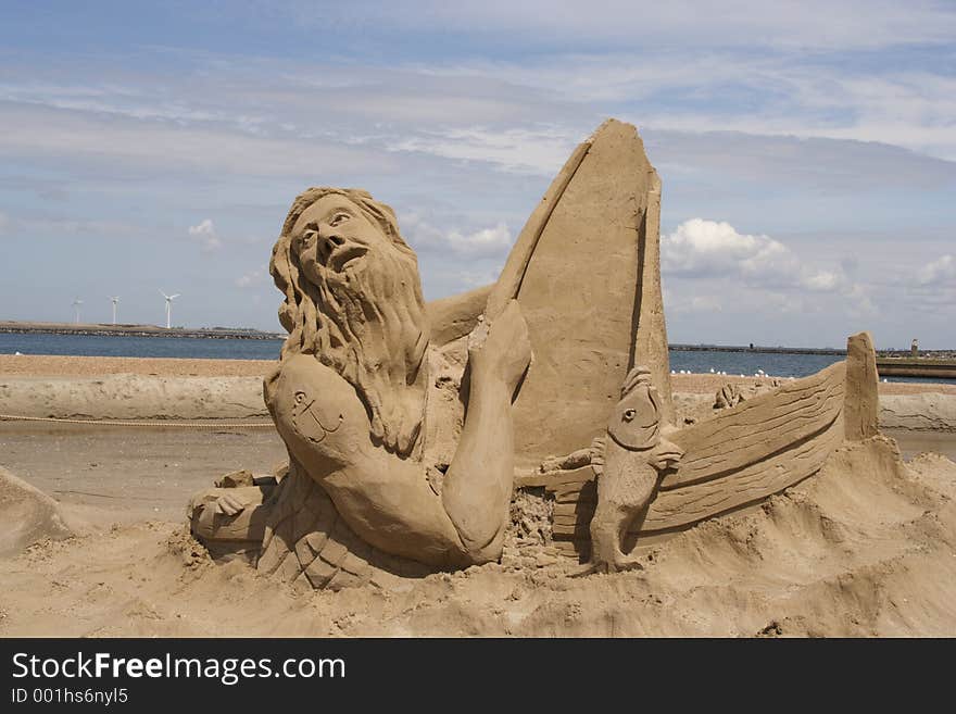 A sailor in his boat made of sand. A sailor in his boat made of sand