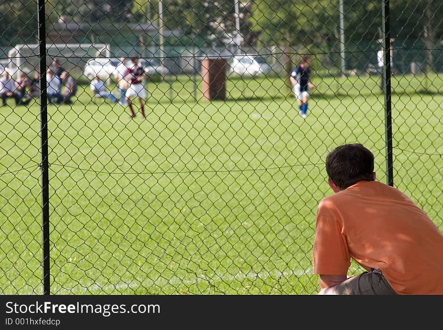 A father assisting to his son football match. A father assisting to his son football match