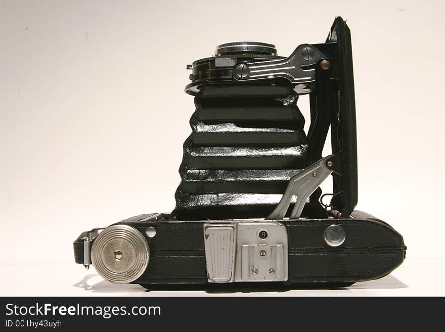 Old open concertina camera from top on white background