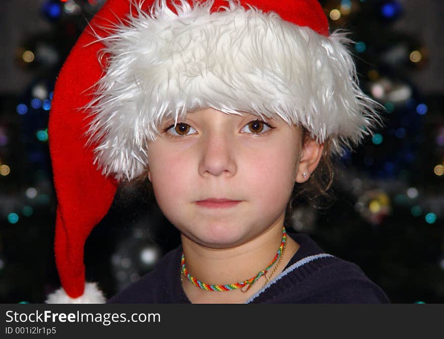 Cute girl in a Christmas hat. Cute girl in a Christmas hat