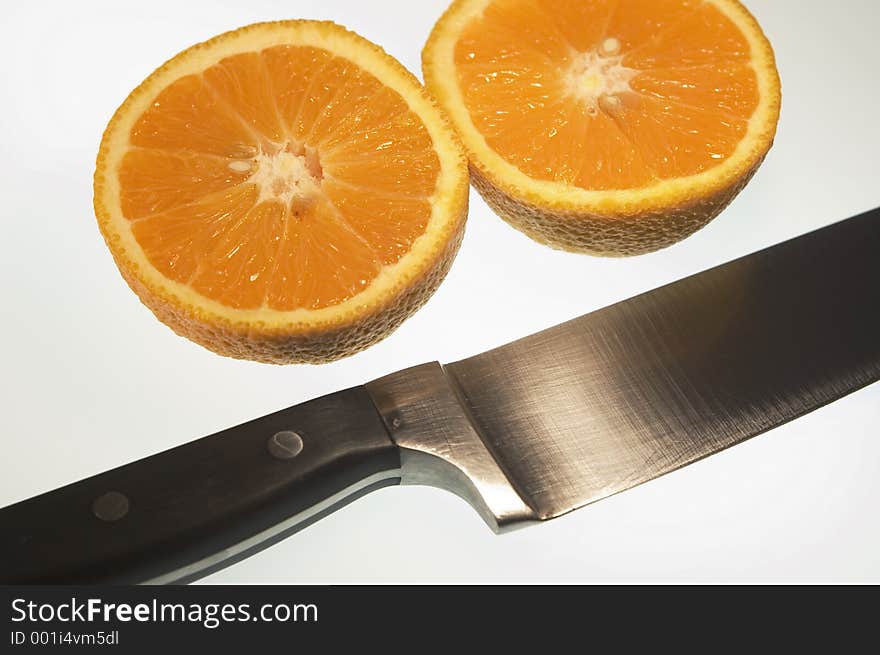 Sliced orange with knife