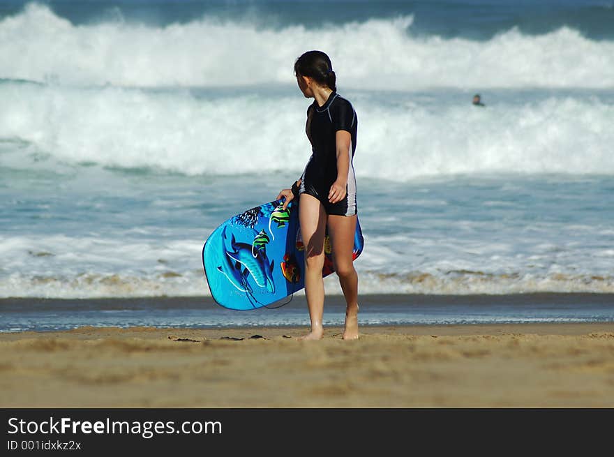 Young girl on beach with her body board. Young girl on beach with her body board