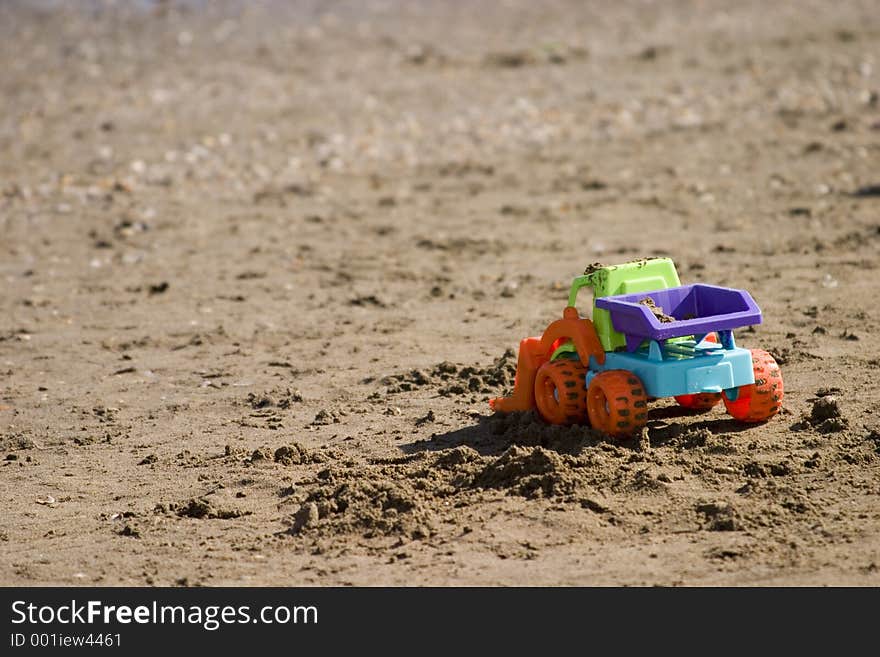 Tractor toy on the beach