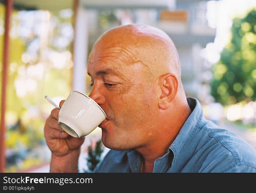 Bald Head Enjoying Coffee And Cigarette