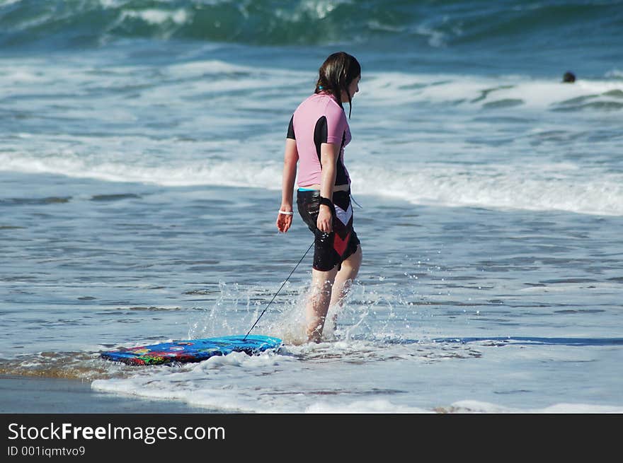 Young girl on beach with her body board. Young girl on beach with her body board