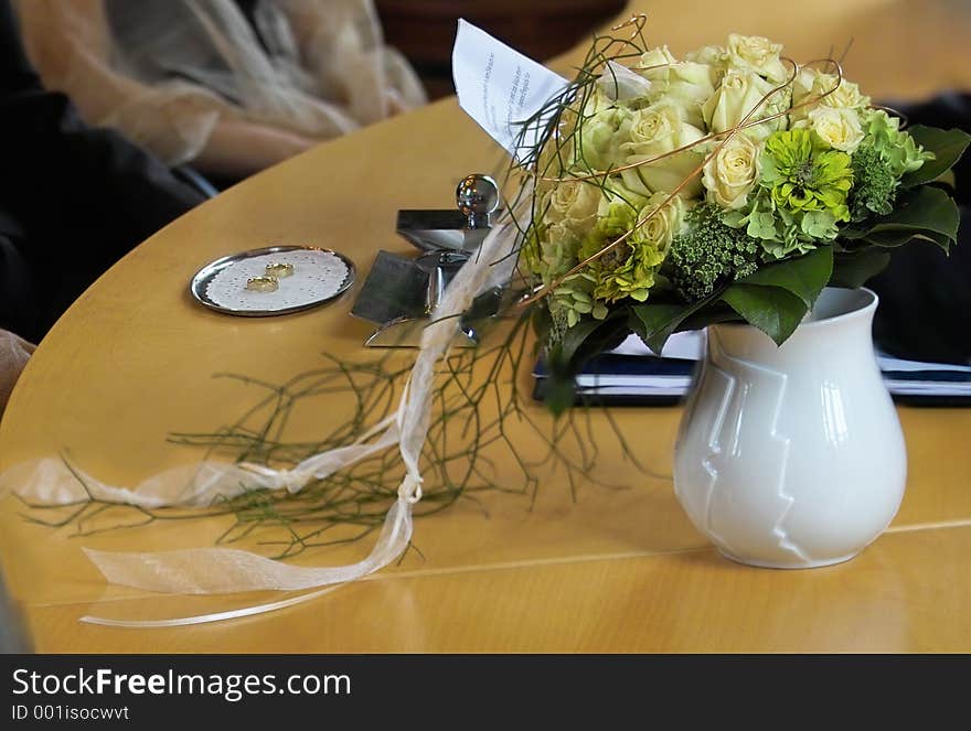 Bridal bouquet and rings by official ceremony