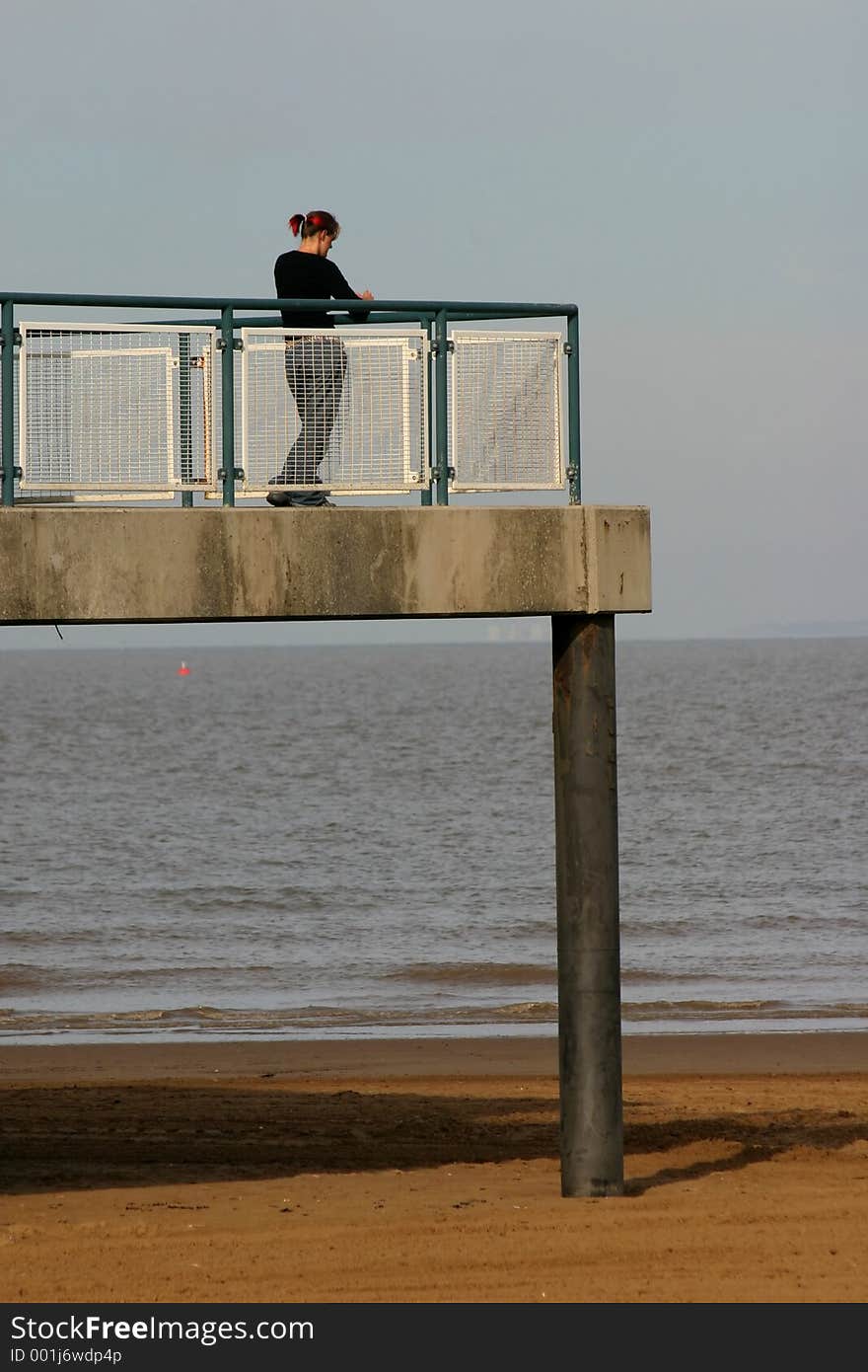 Girl standing at teh end of the pier. Girl standing at teh end of the pier