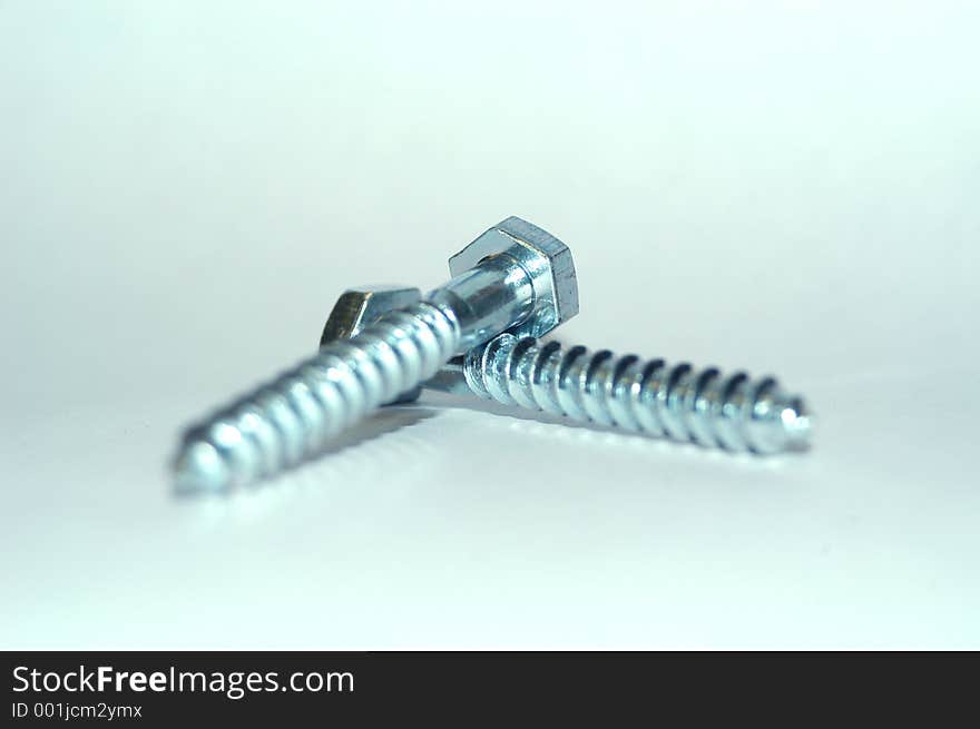 Two bolt lying on top of each other. Isolated from background. Two bolt lying on top of each other. Isolated from background.