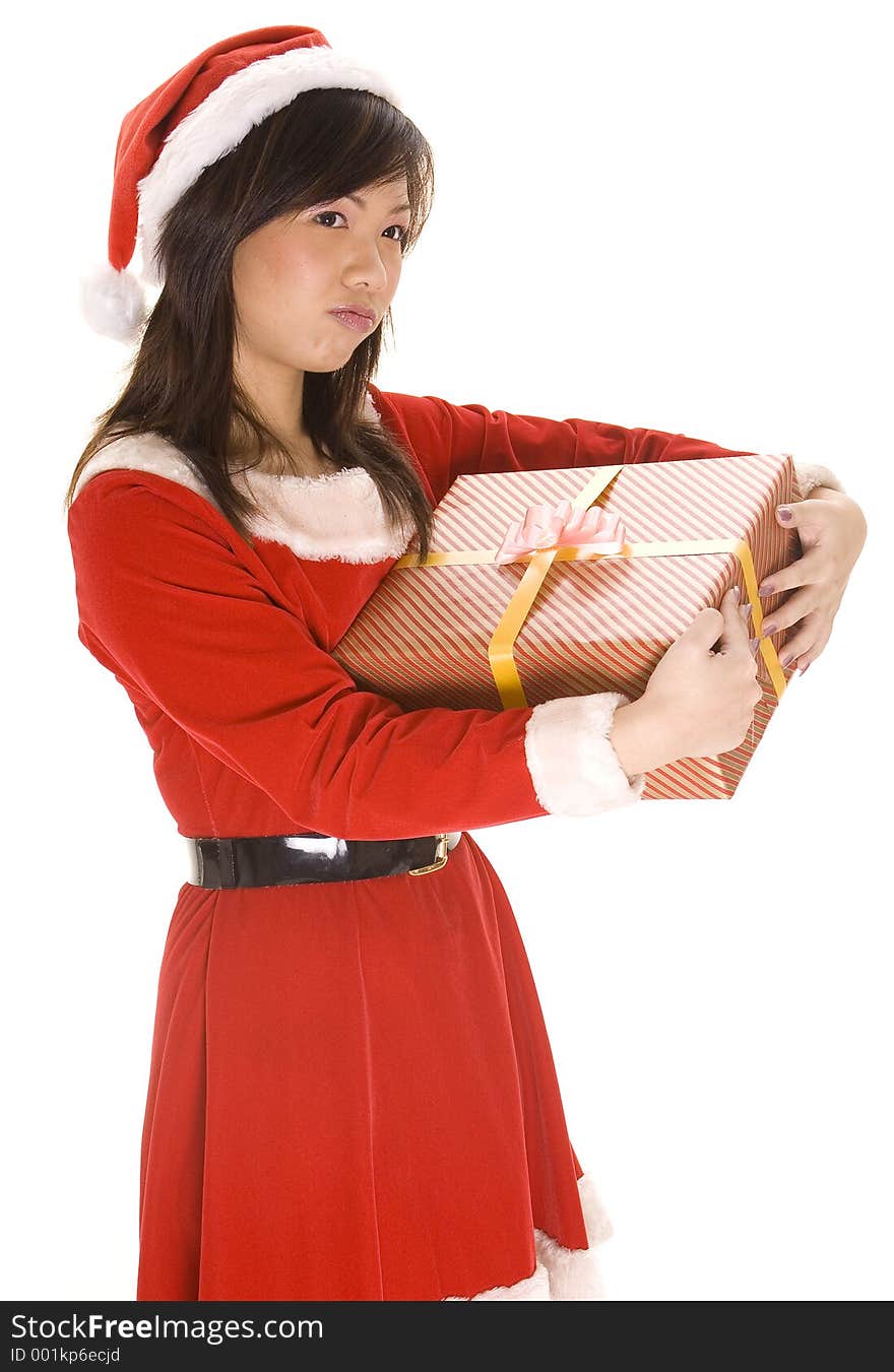 A female santa claus thinks about keeping a present for herself. A female santa claus thinks about keeping a present for herself