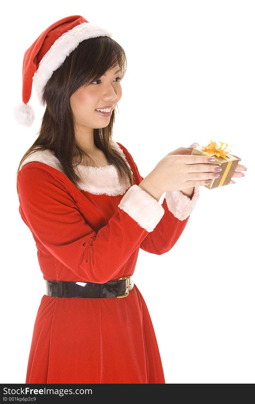 A cute asian woman dressed in a santa costume gives someone a small present