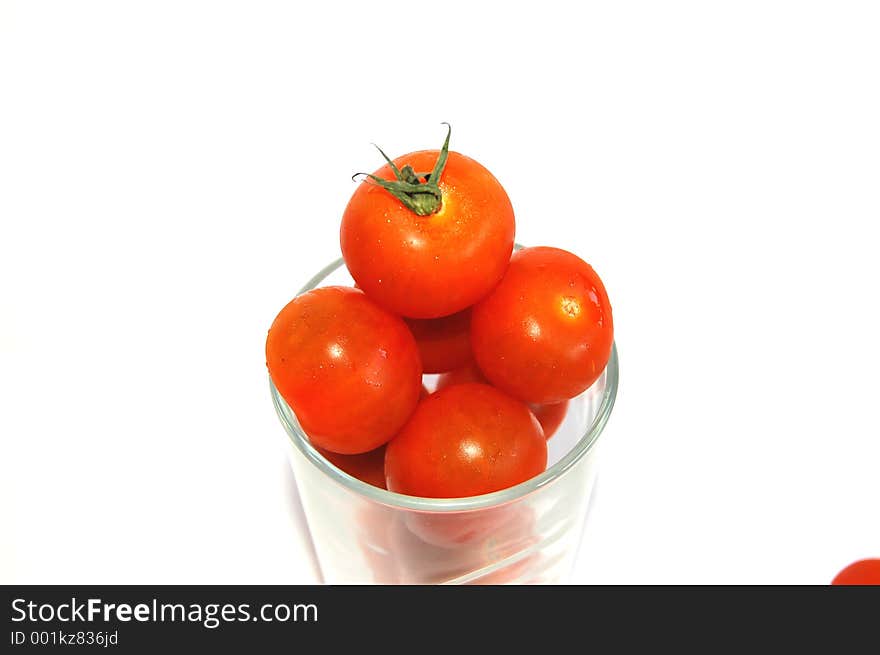 This is a close up of a set of cherry tomatoes in a glass. This is a close up of a set of cherry tomatoes in a glass.