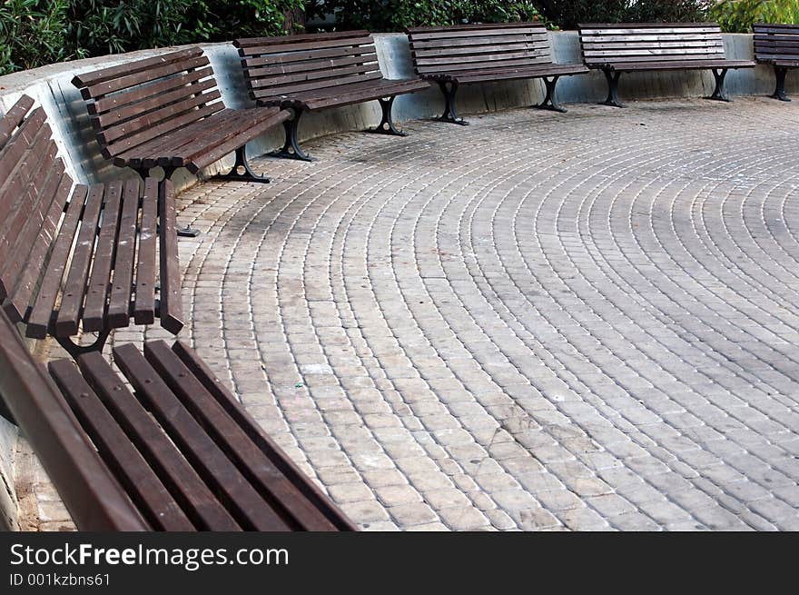 Benches in a semicircle with stone floor