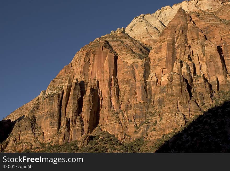 Canyon walls at Zion National Park lit by the sunset light. Canyon walls at Zion National Park lit by the sunset light