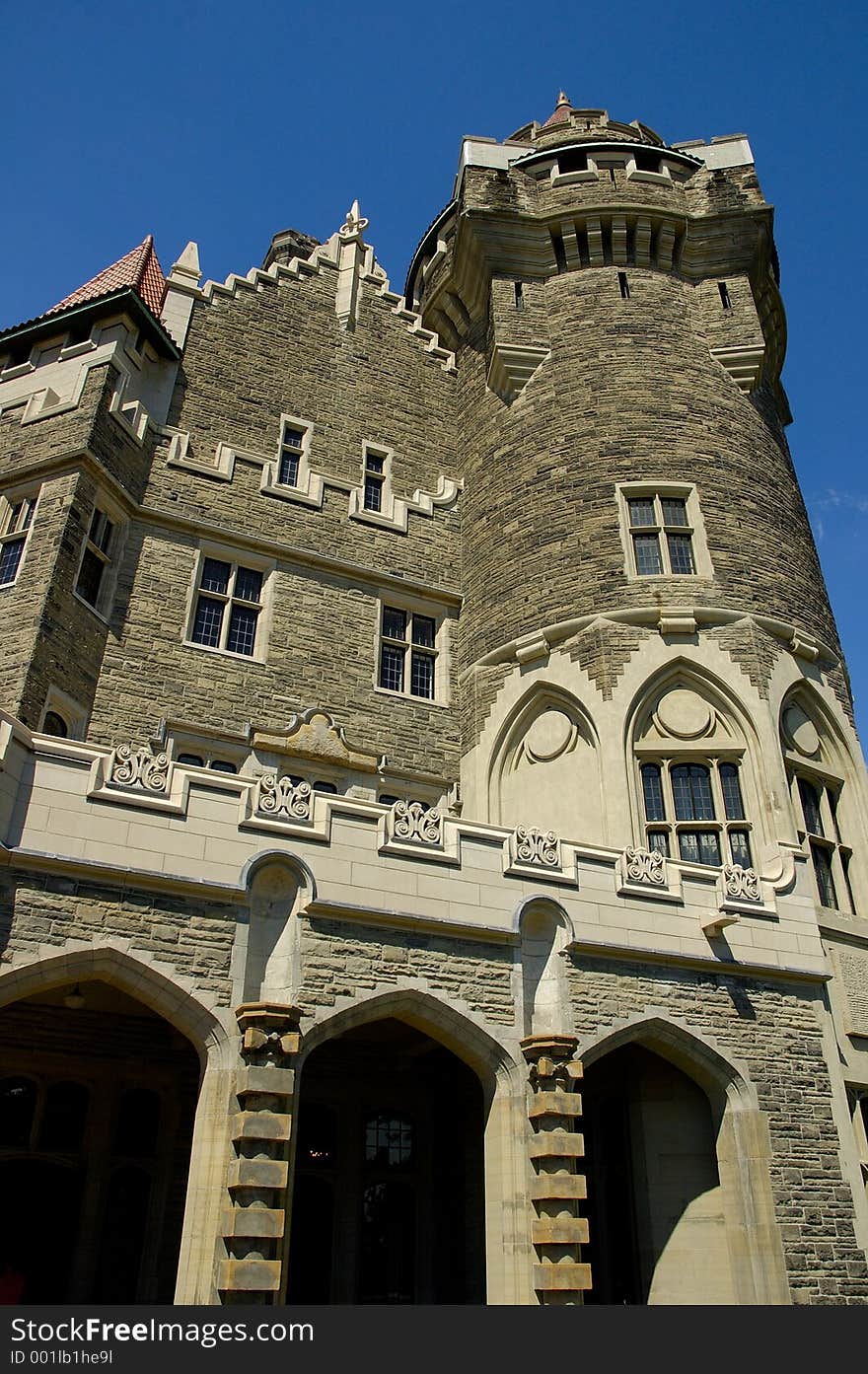 A view looking up at the corner of an ancient castle, with a bright blue sky above. A view looking up at the corner of an ancient castle, with a bright blue sky above.