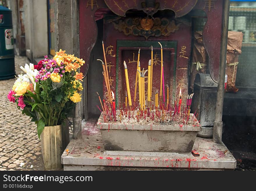 Joss sticks burn at a streetside altar in Macau, a Special Administrative Region of China.