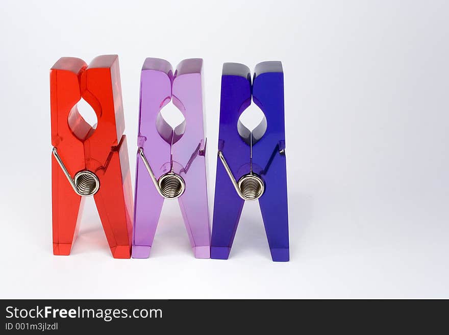 Row of 3 plastic clips against white background. Row of 3 plastic clips against white background