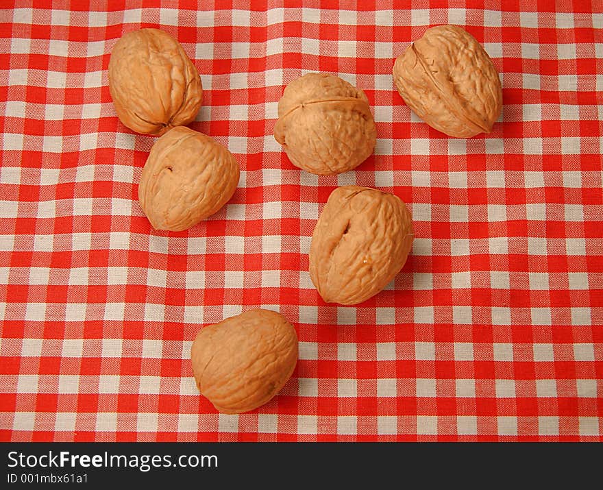 Six nuts over a tablecloth