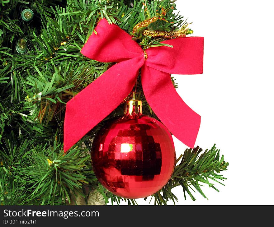 Red bow and round ornament hanging from Christmas Tree. Red bow and round ornament hanging from Christmas Tree