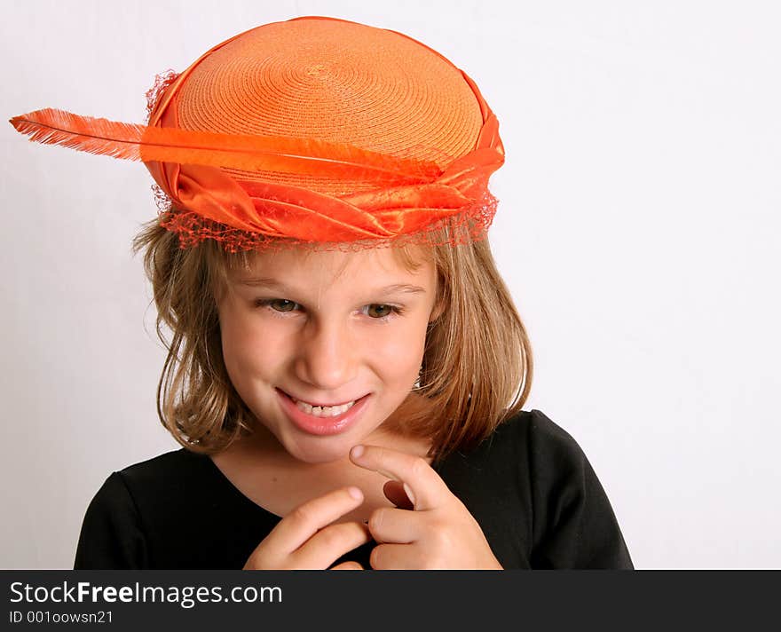 Young smiling girl with orange women's hat on