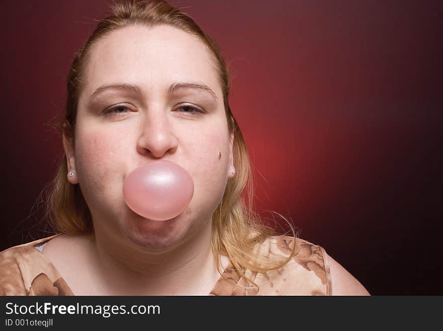 Women blowing small bubble gum. Women blowing small bubble gum