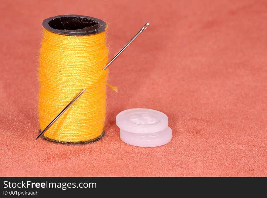 Needle with thread and buttons. Needle with thread and buttons.