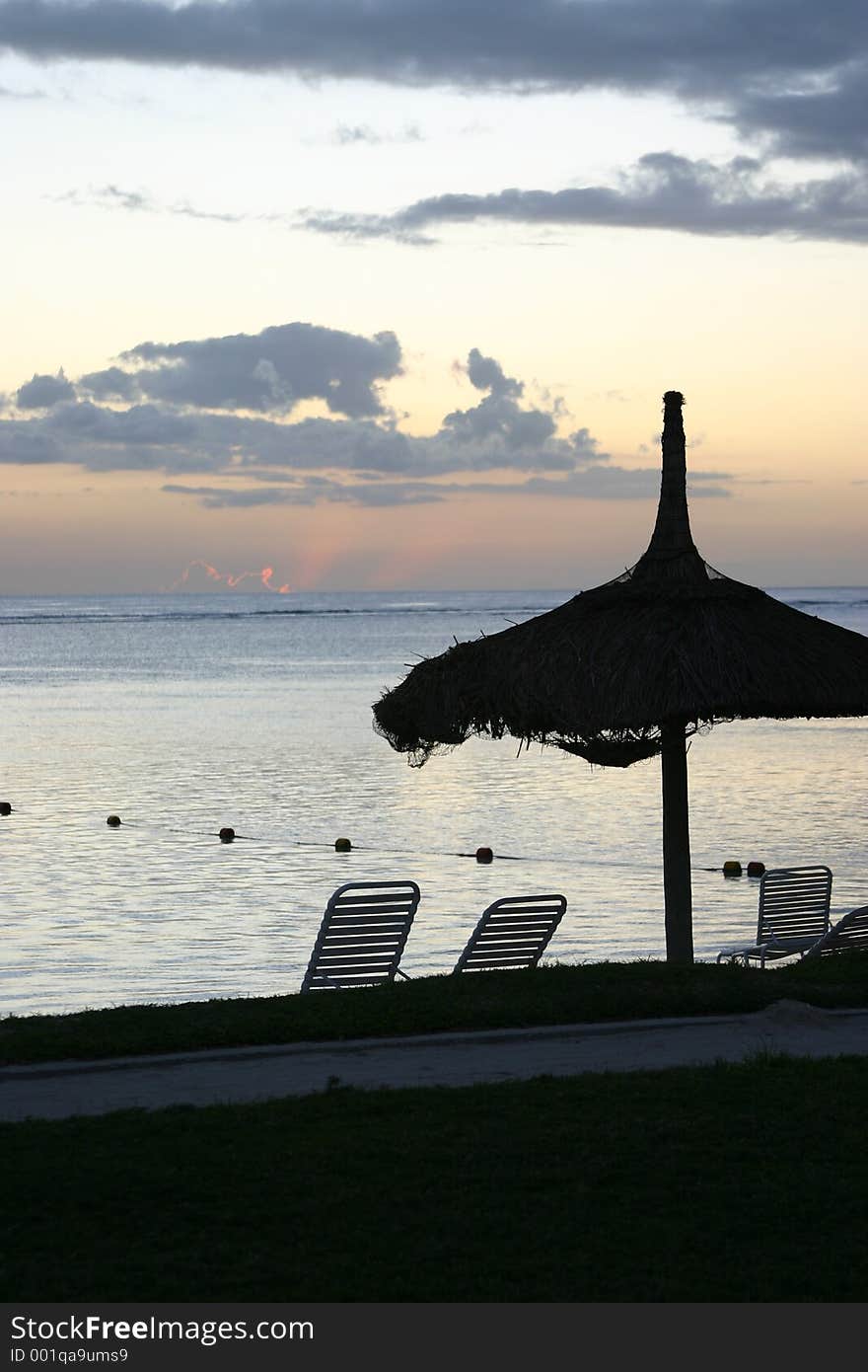 Sunset over Mauritius with beach umbrella