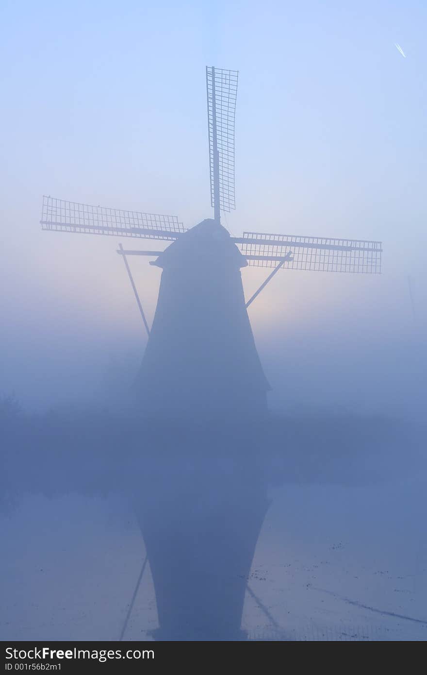 Windmill at a misty morning