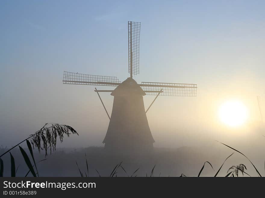 Windmill at a misty morning