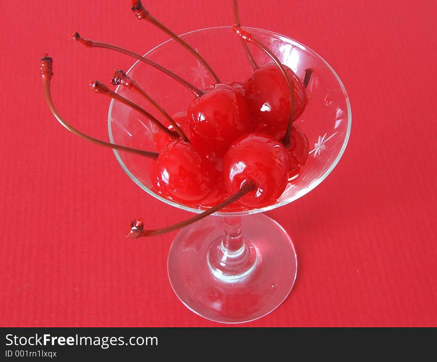 Red maraschino cherries in a martini glass. Red maraschino cherries in a martini glass.