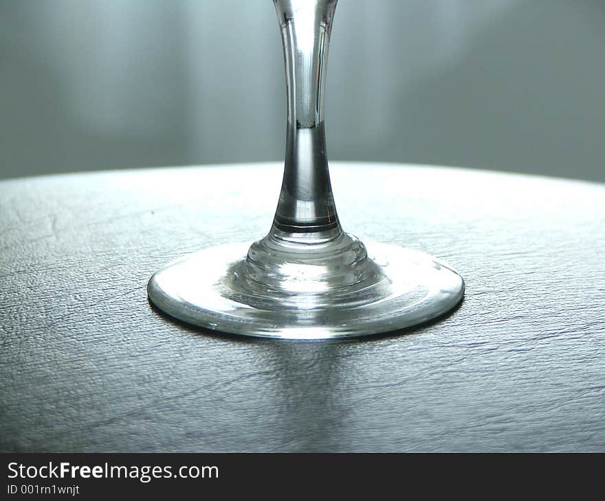 Wine glass stem, on black leather tray.