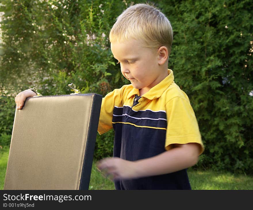 Boy and briefcase,movement on hand. Boy and briefcase,movement on hand