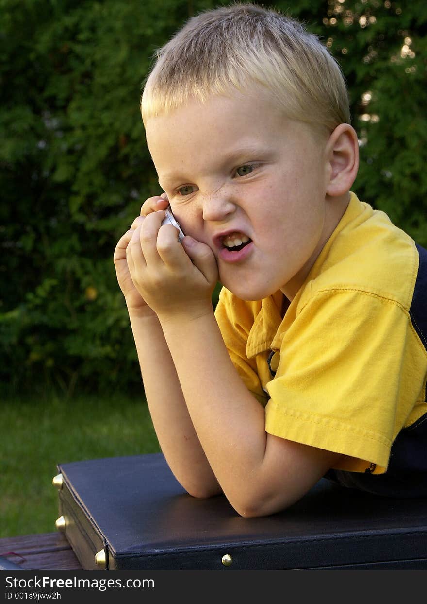 Boy not impressed with his caller. Boy not impressed with his caller