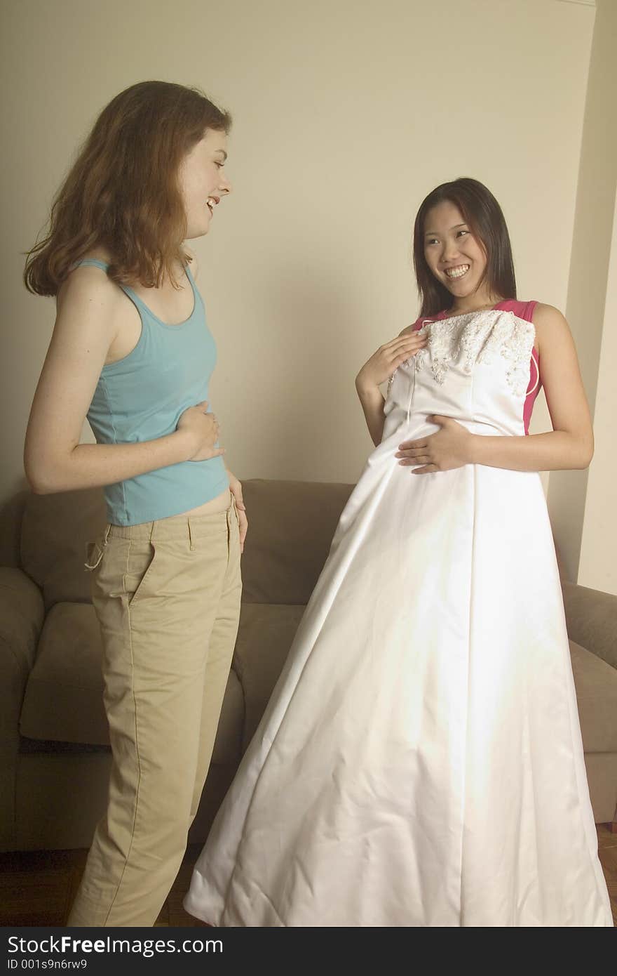 Young woman shows her friend her wedding dress. Young woman shows her friend her wedding dress