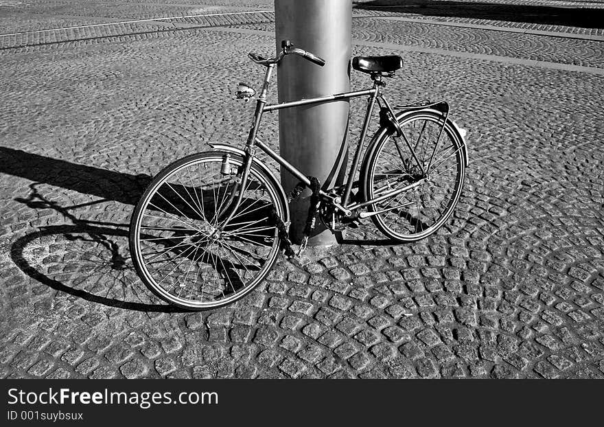 Bicycle near a pillar, in the afternoon sunlight (b&w pic). Bicycle near a pillar, in the afternoon sunlight (b&w pic)