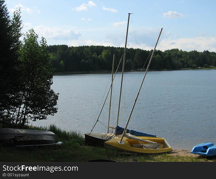 Boats beached on a lake shore. Boats beached on a lake shore