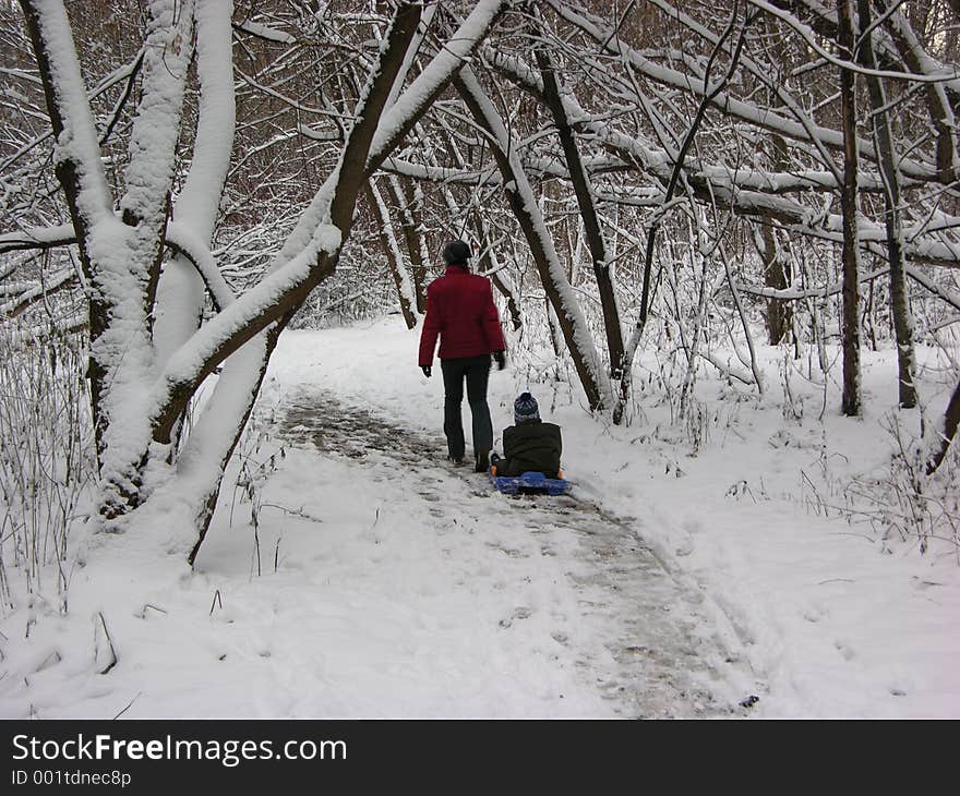 Mother with child in winter wood