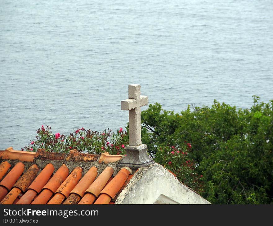 Stone textured cross on the roof