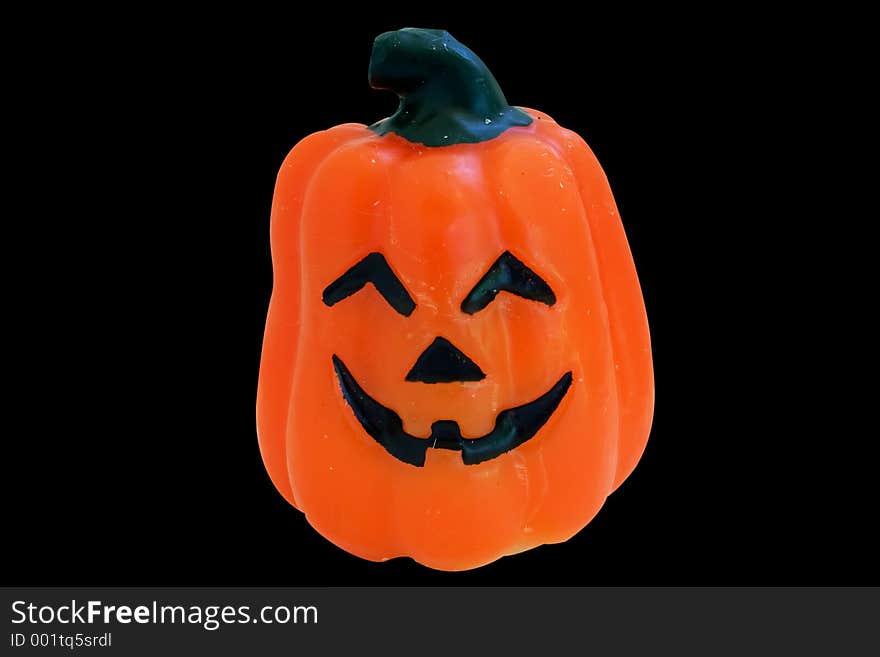 Pumpkin candle isolated on black background