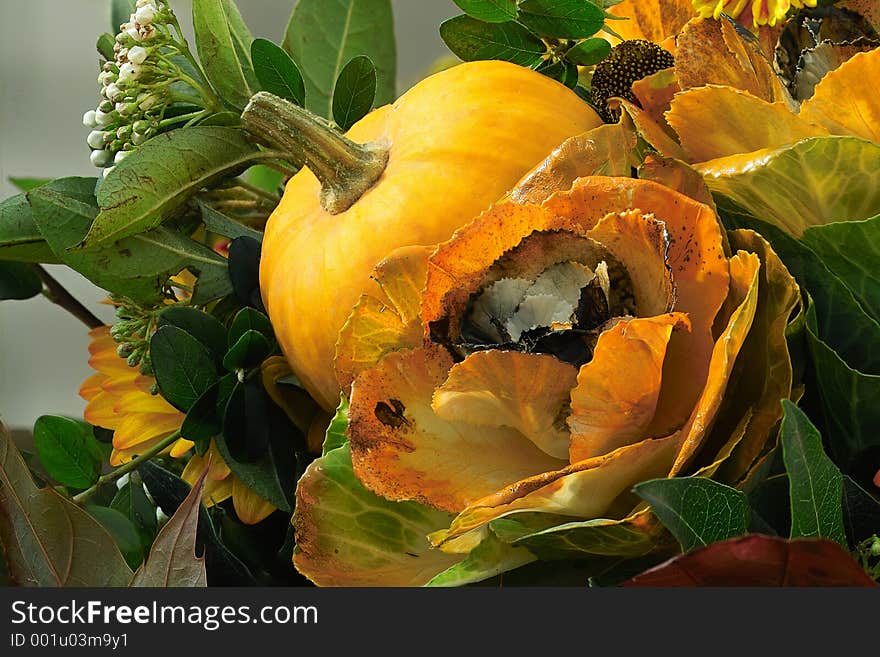 Autumn decoration with pumpkin and flowers