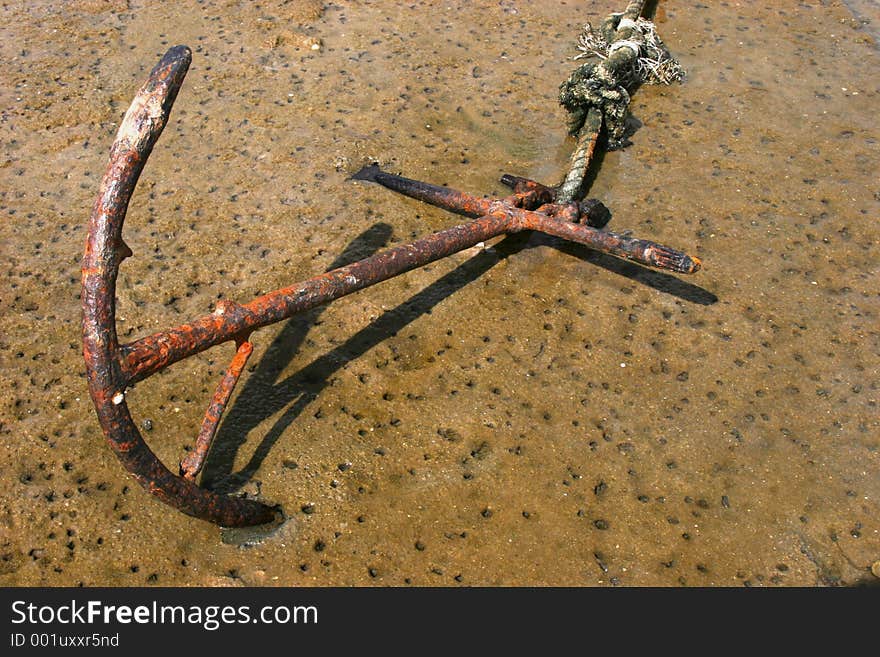 Rusted Anchor in shallow sea water