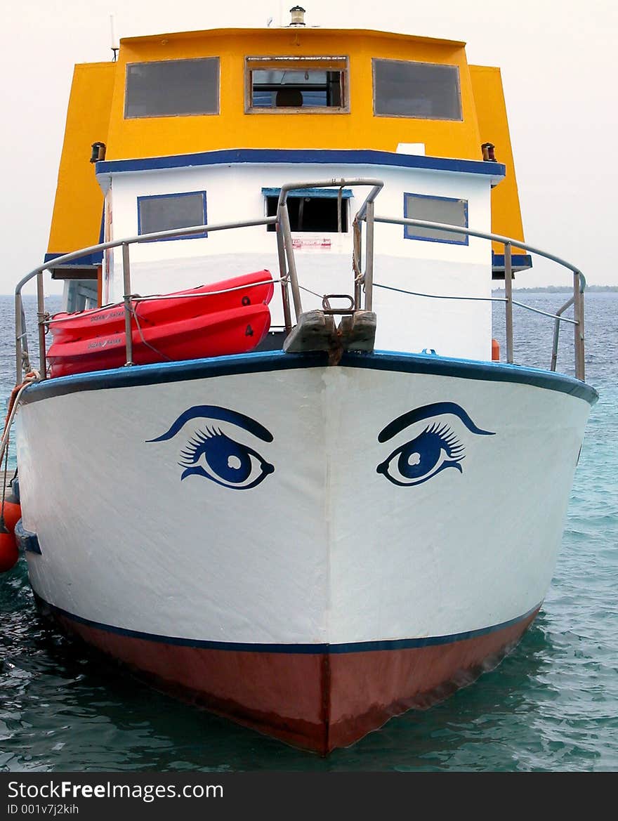 Head on view of an old boat with eyes painted on it. Head on view of an old boat with eyes painted on it