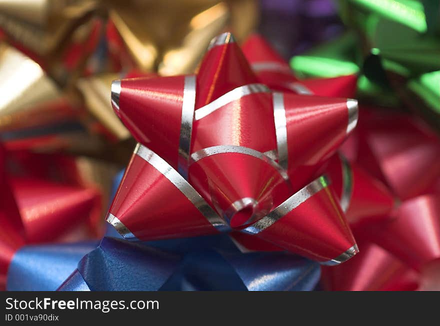 Red and Silver Christmas Bow laying on a variety of other bows