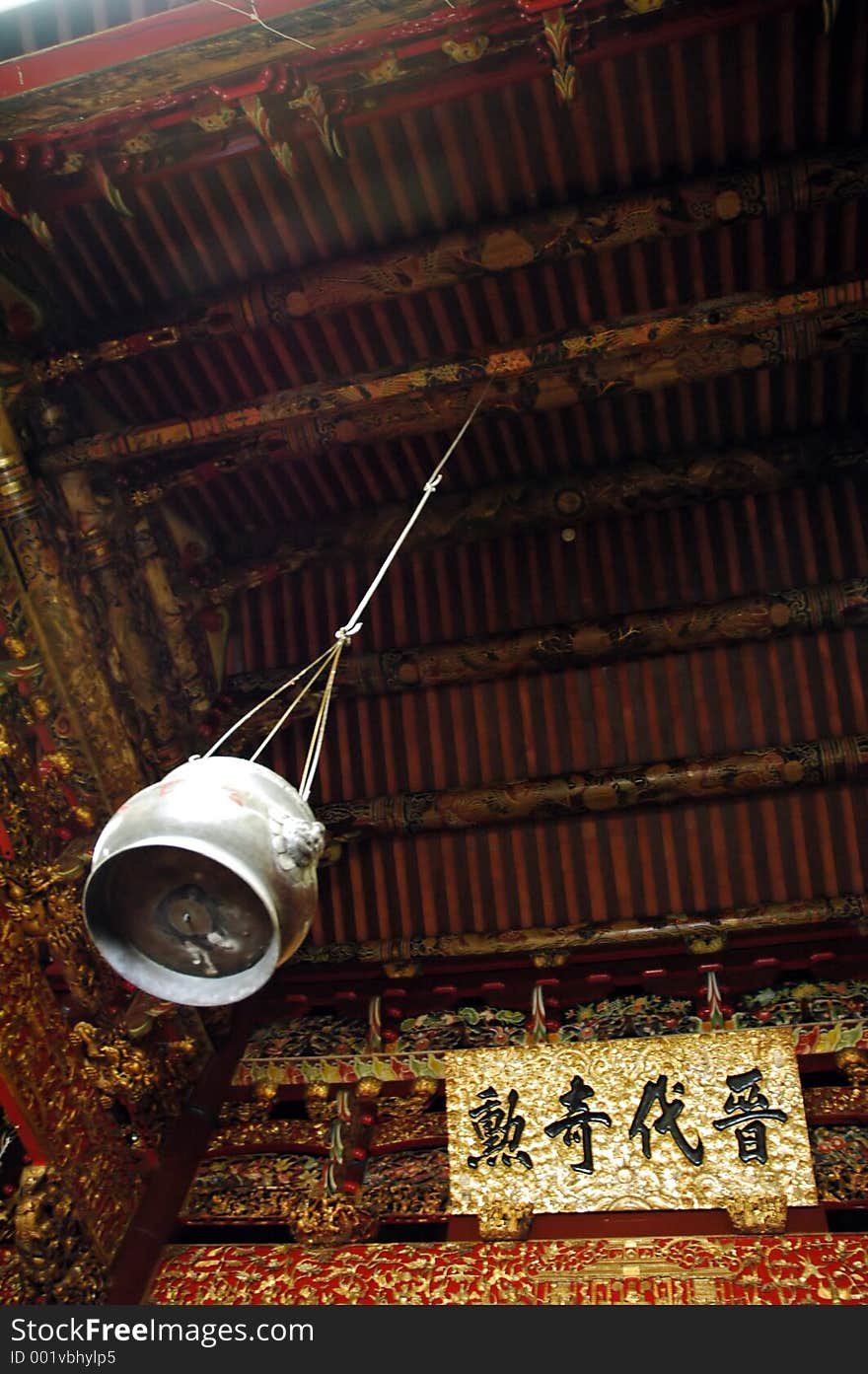 An urn hanging by a very old vintage building roof top