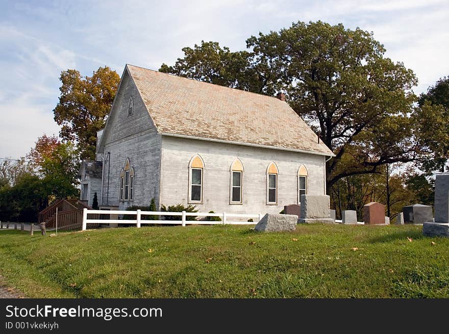 A small country church with a graveyard. A small country church with a graveyard.